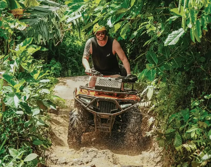 ATV riders on a tropical trail at Pertiwi Adventure